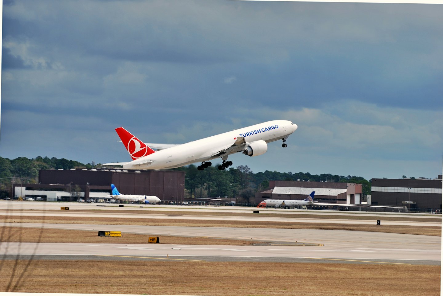 A Turkish Cargo plane takes off from the airport runway.